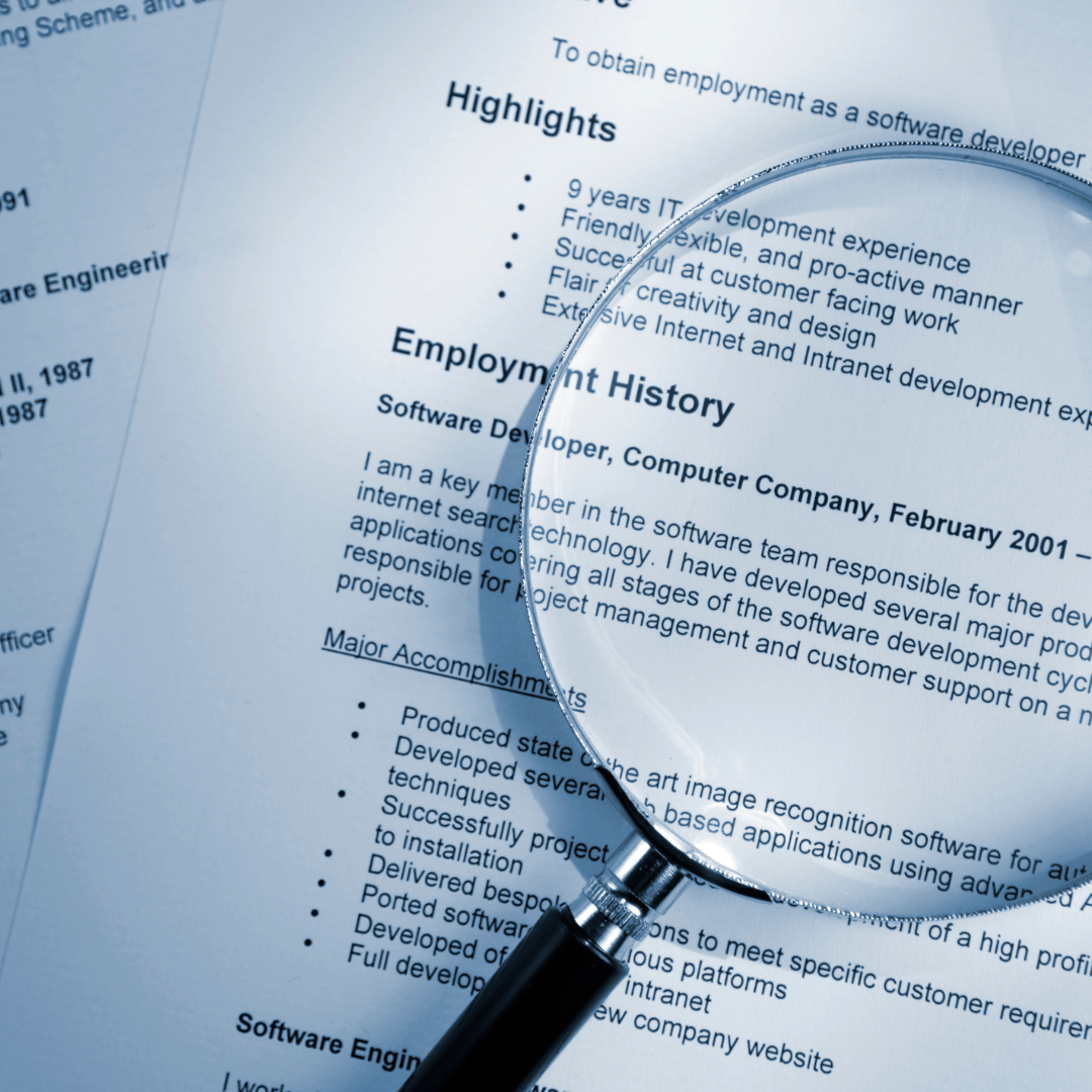 An executive CV with a magnifying glass over over the top
